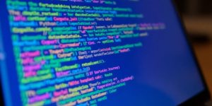 Python code snippets on a laptop screen.